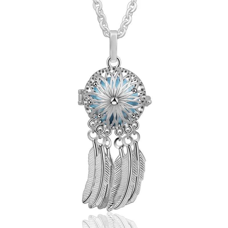 Silver dreamcatcher pendant with feathers on a white background