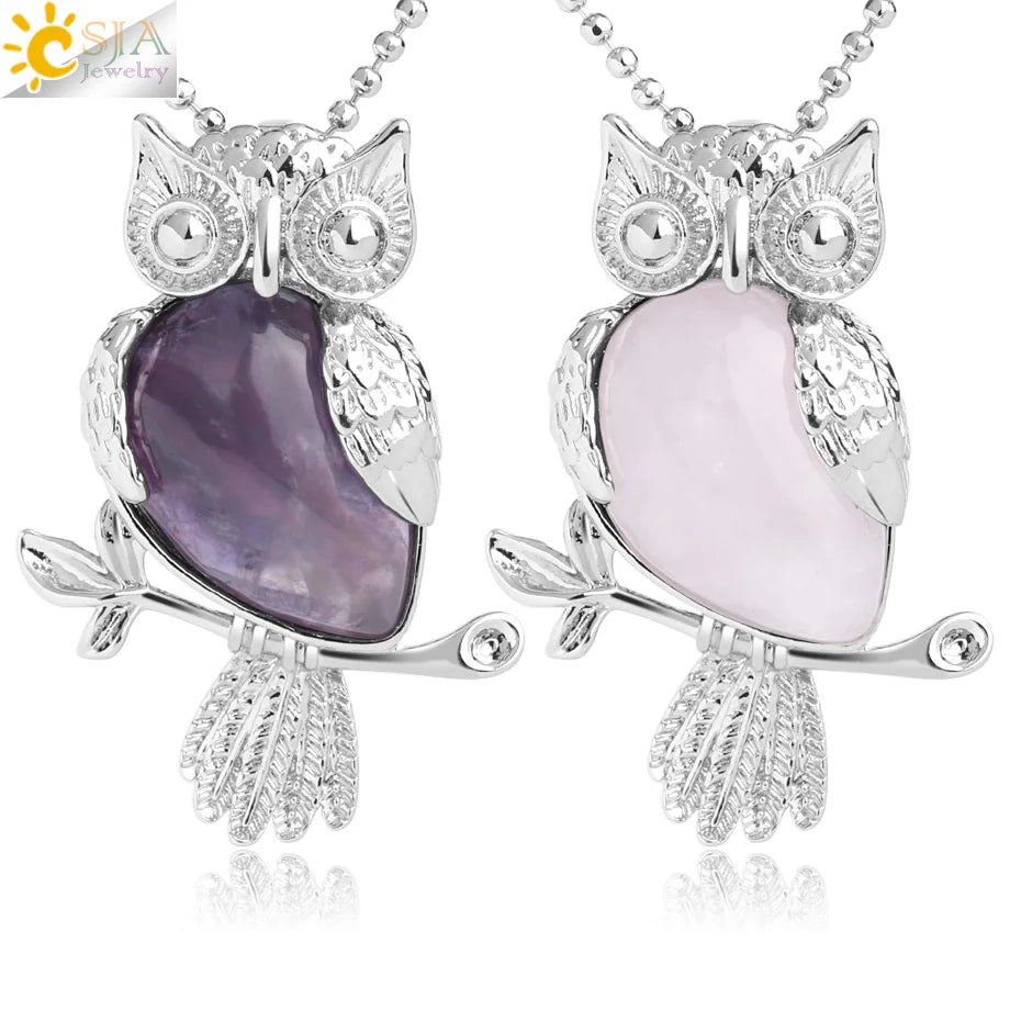 Two owl-shaped necklaces with purple and pink stones on a white background