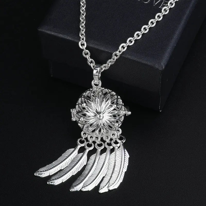 Silver dreamcatcher pendant necklace on a black background