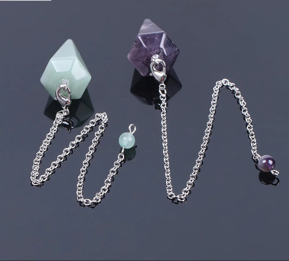 Jewelry set with silver chains and gemstone pendants on a dark background