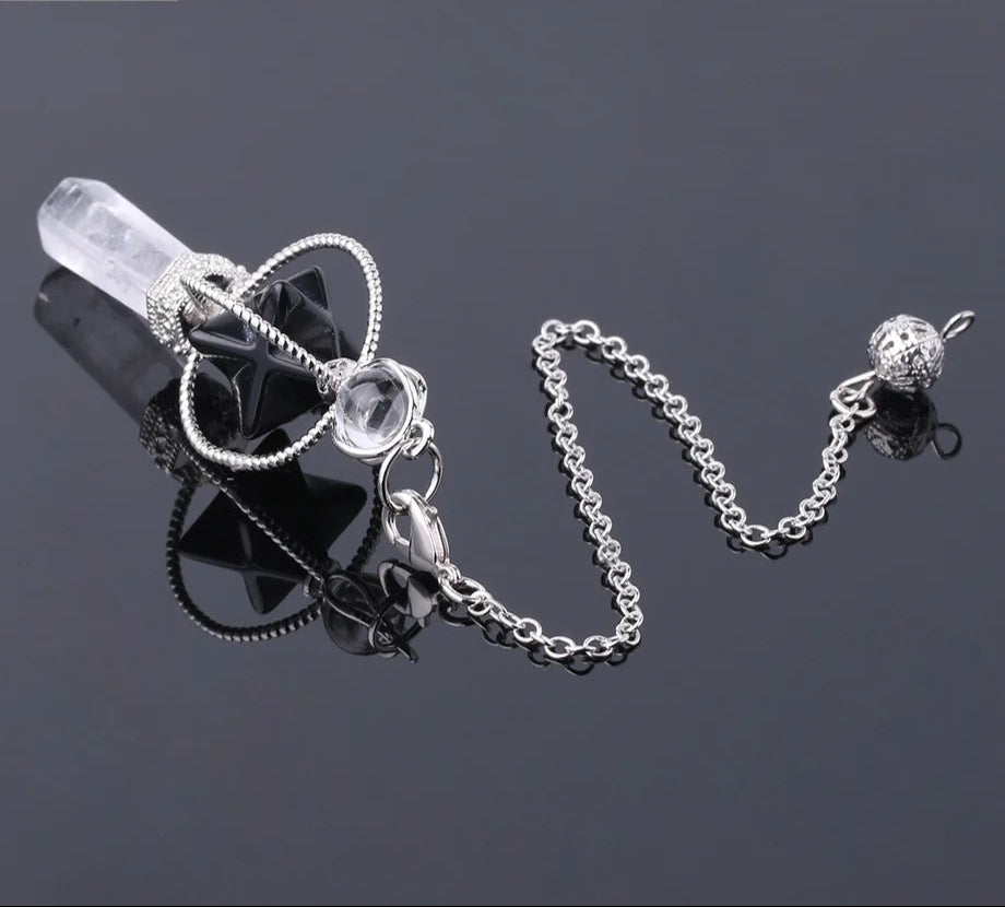 Silver necklace with clear pendant on a dark background