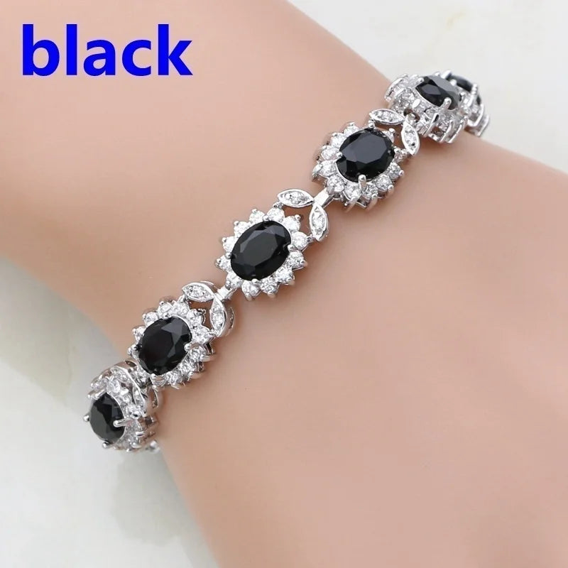 Black gemstone bracelet on a wrist with 'black' text above.