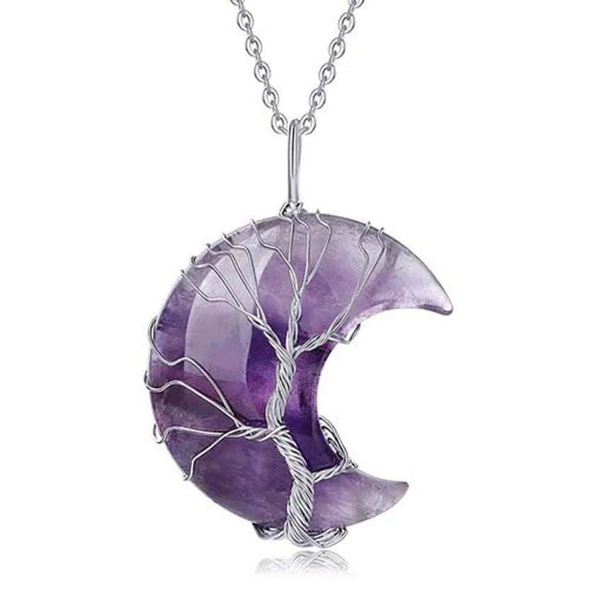 Purple crescent moon-shaped pendant with silver tree design on a white background