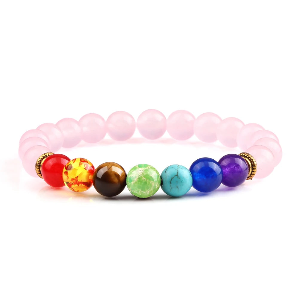 Colorful beaded bracelet with pink elastic band on a white background
