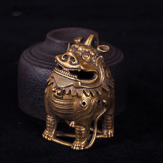Bronze lion statue on a dark background