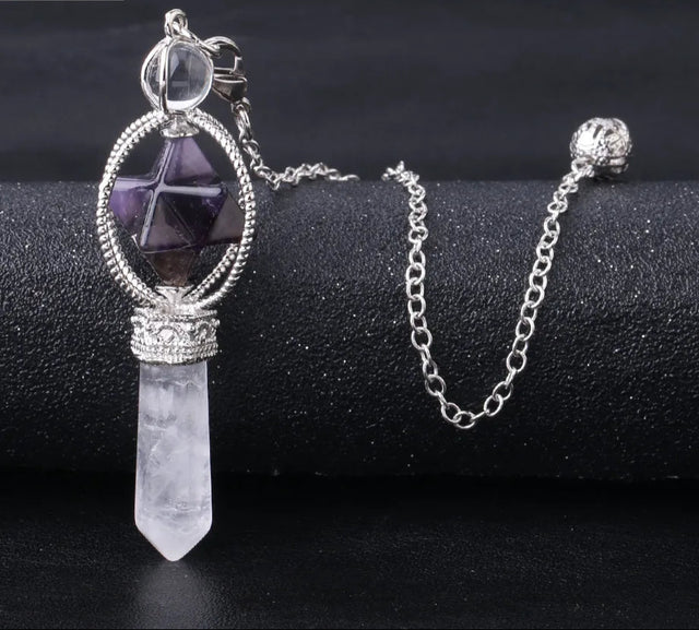 Crystal pendant necklace on a black surface with 'Cala Jewelry' logo.