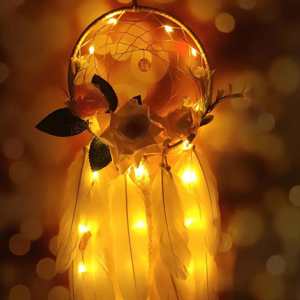 Decorative dreamcatcher with lights and flowers against a warm, blurred background