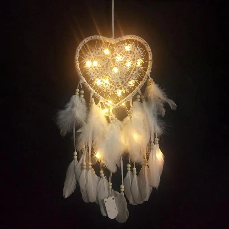 Heart-shaped dreamcatcher with LED lights on a dark background