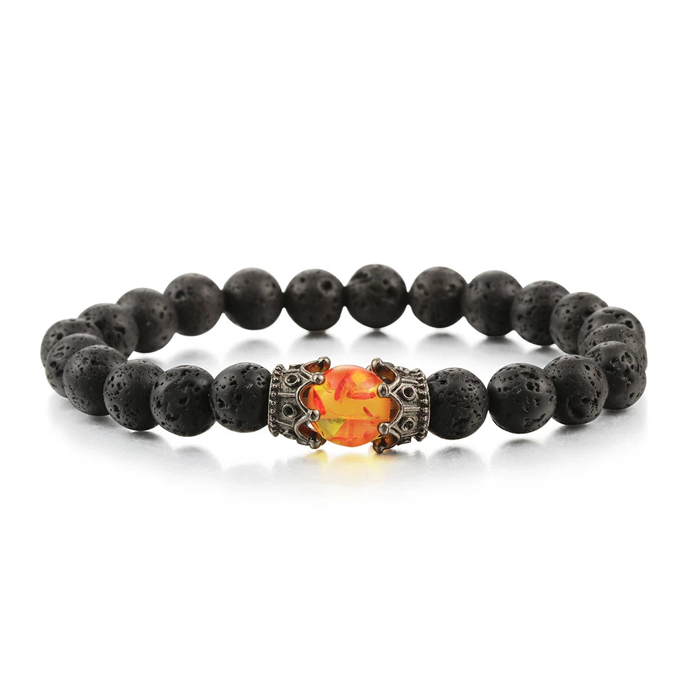 Lava stone bracelet with a decorative orange and silver bead on a white background