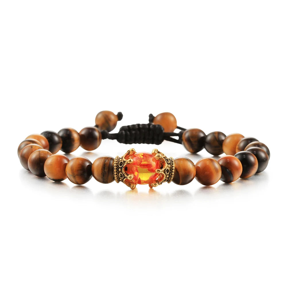 Bracelet with tiger eye beads and a prominent orange gemstone on a white background