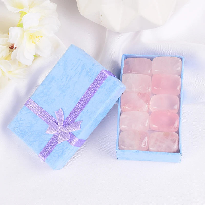 Pink stones in a light blue box with a ribbon on a white background
