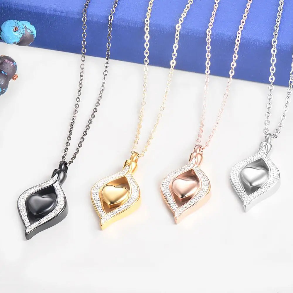 Four heart-shaped pendants on necklaces with different color chains against a blue and white background.