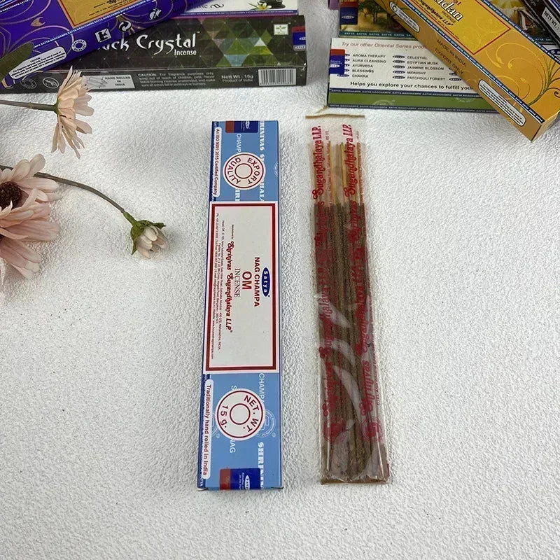 Incense stick packaging with incense sticks on a textured surface with flowers.