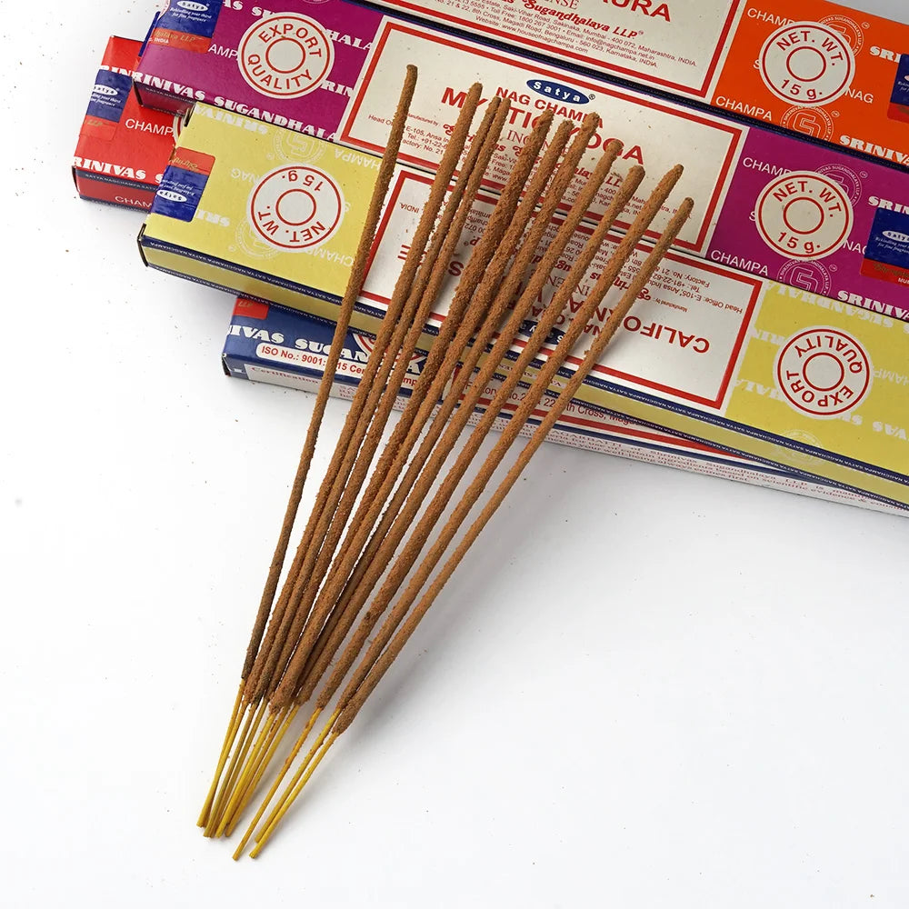 Incense sticks in front of colorful boxes on a white background