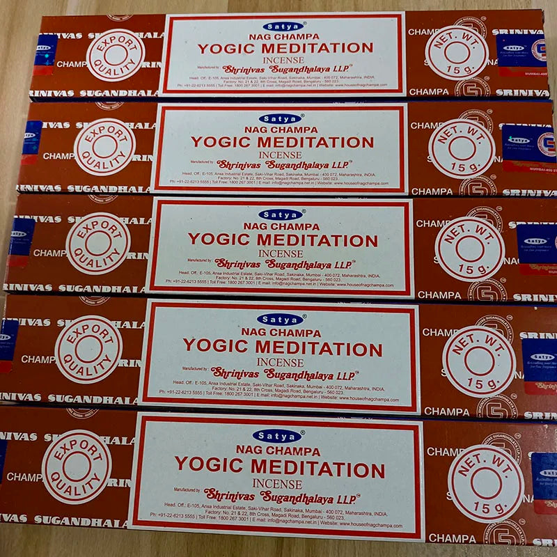 Multiple boxes of Satya Nag Champa Yogic Meditation incense on a wooden surface