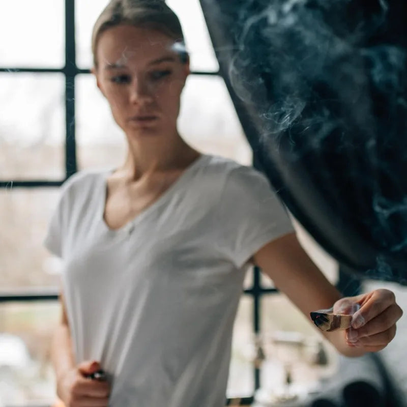 Person holding a incense with a blurred background