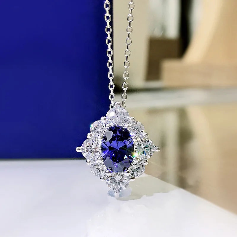 Silver necklace with a pendant featuring a purple gemstone on a white surface.