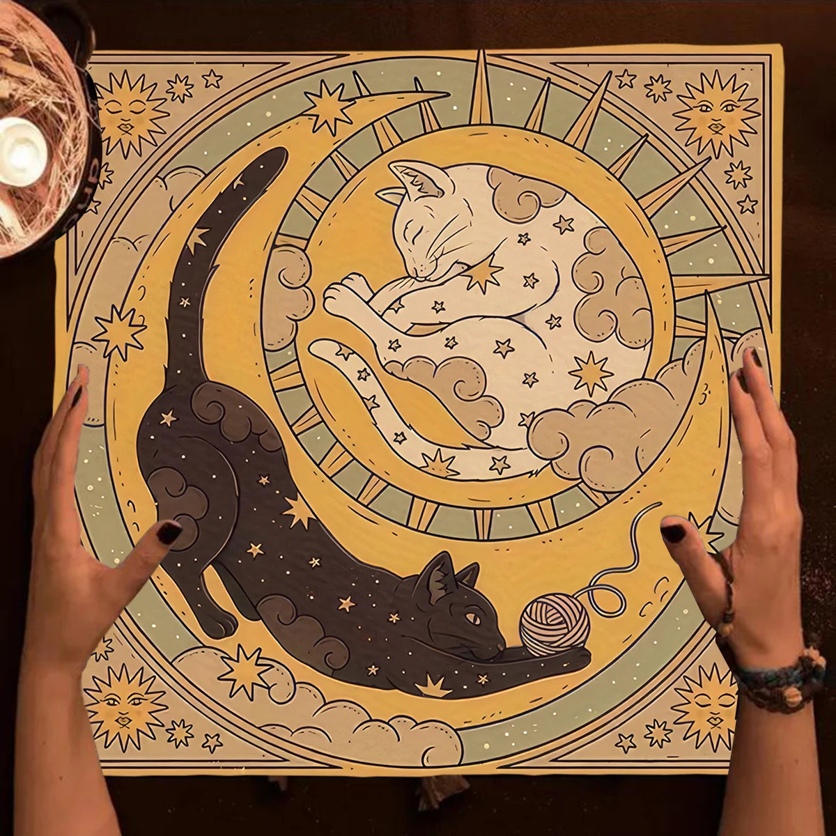 Illustration of two cats on a moon with stars, held by hands against a dark background.