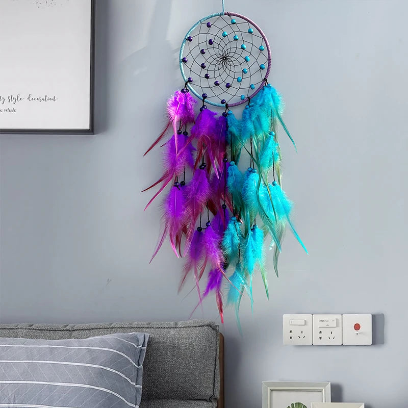 Colorful dreamcatcher hanging on a wall above a sofa.