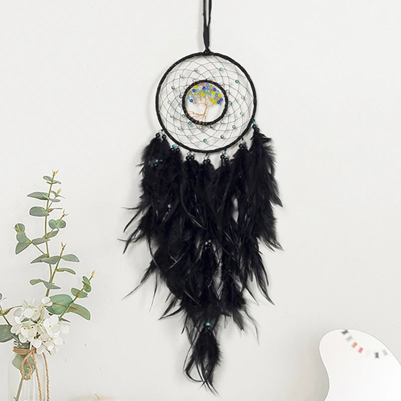 Black feathered dreamcatcher with a central design on a white background