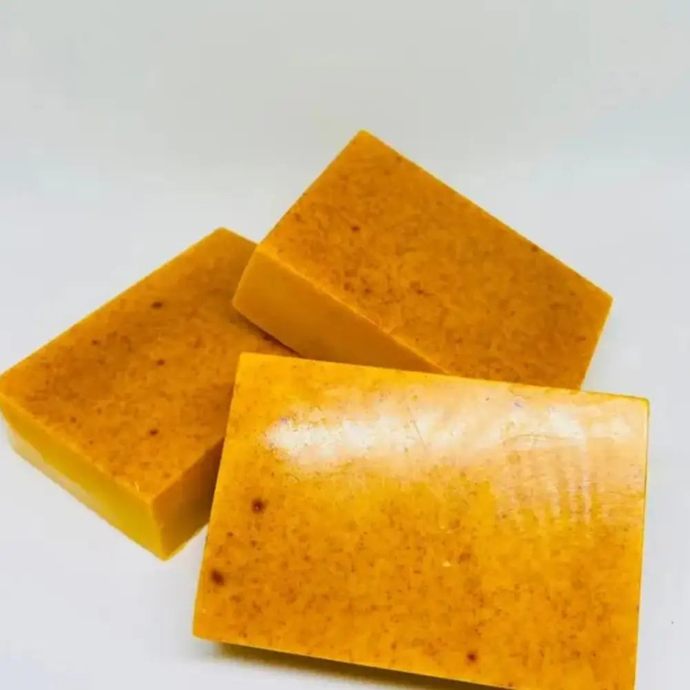 Three orange soap bars on a white background