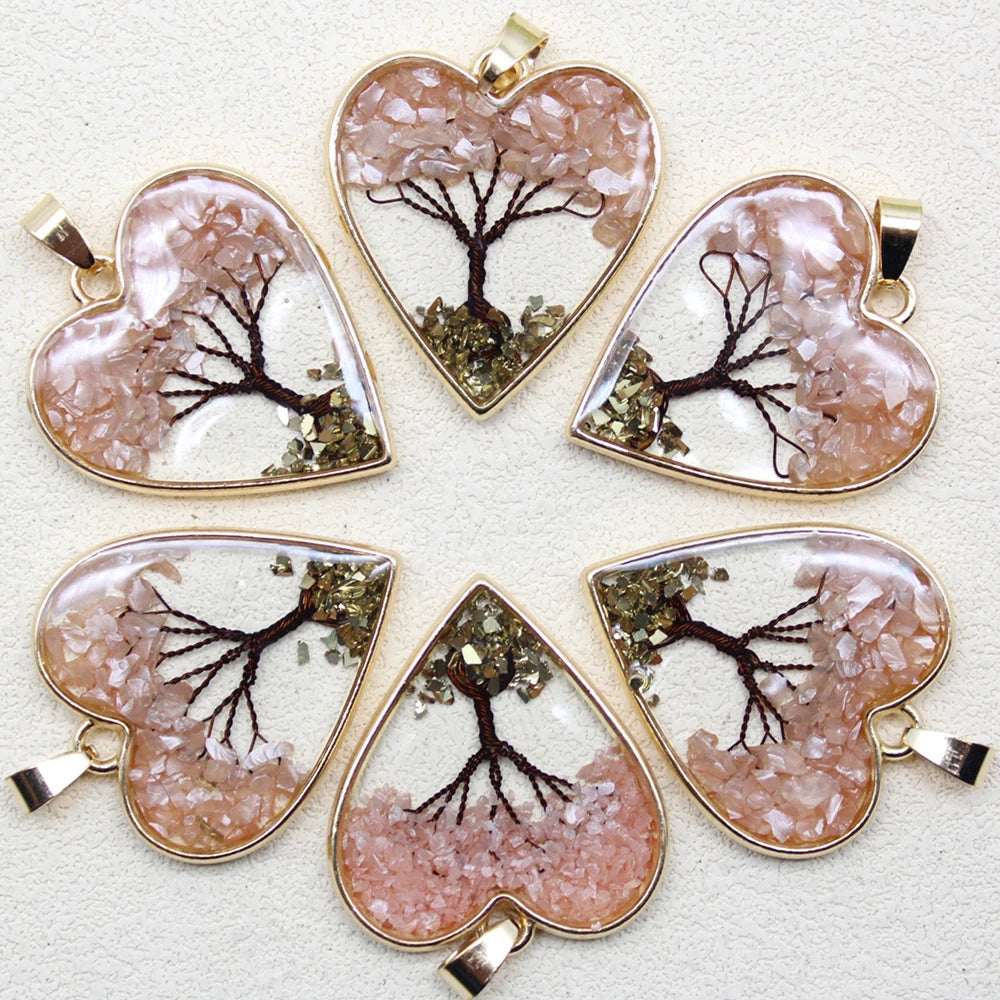 Heart-shaped pendants with tree designs on a light background