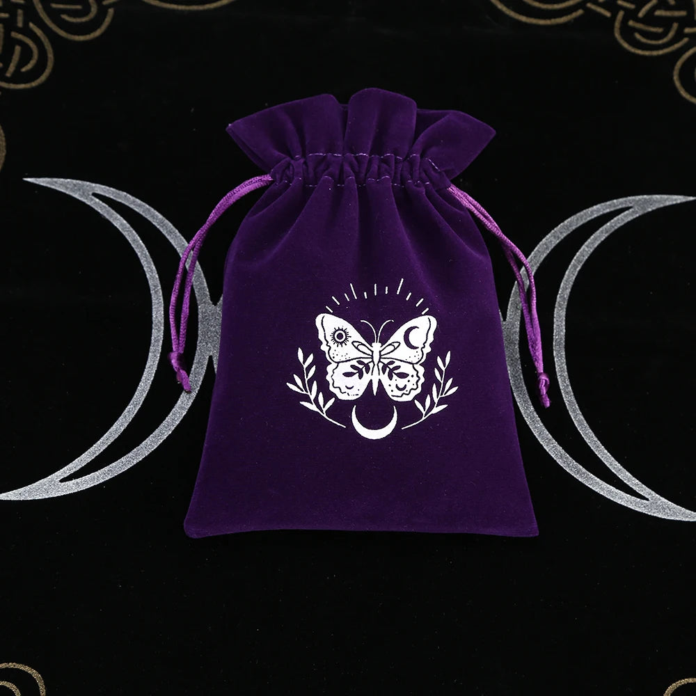 Purple drawstring bag with a white butterfly design on a black background with wiccan symbols.