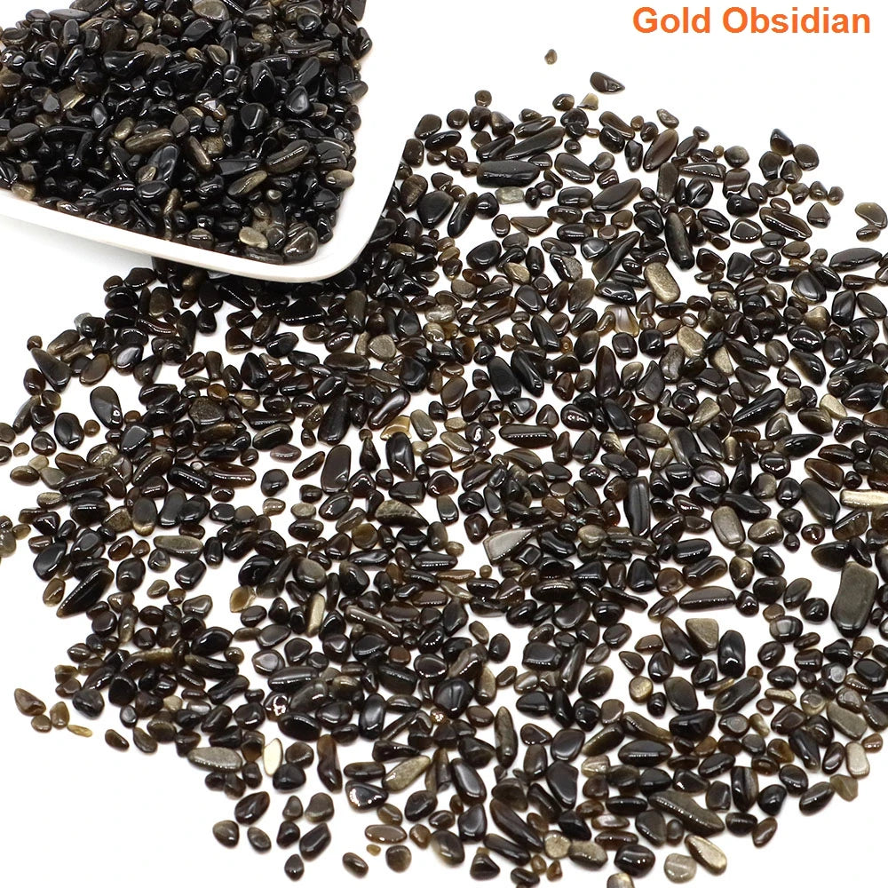 Gold Obsidian stones with a white scoop on a white background