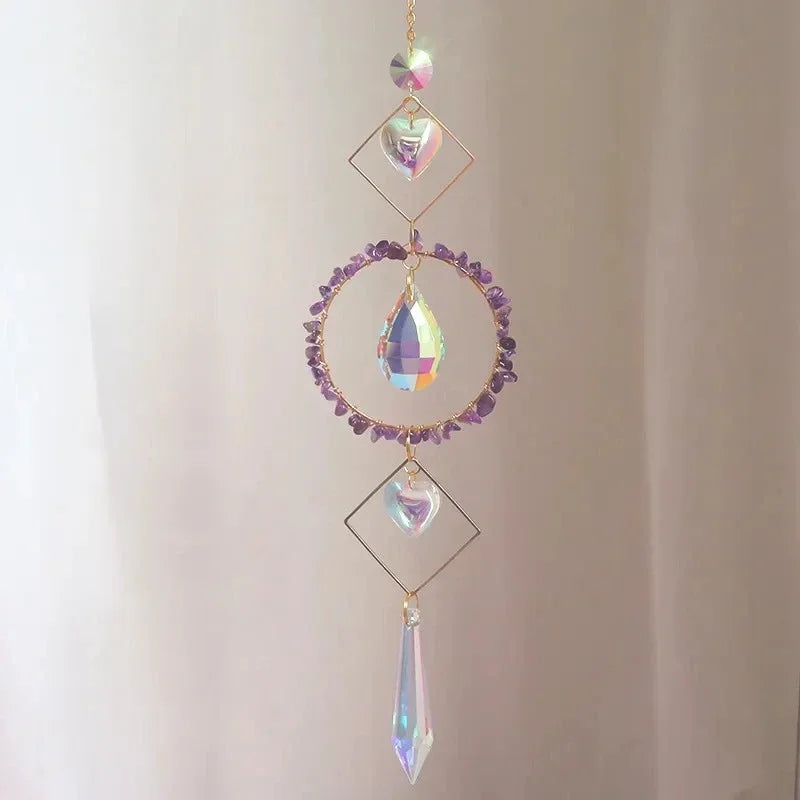 Decorative hanging crystal with purple stones on a plain background