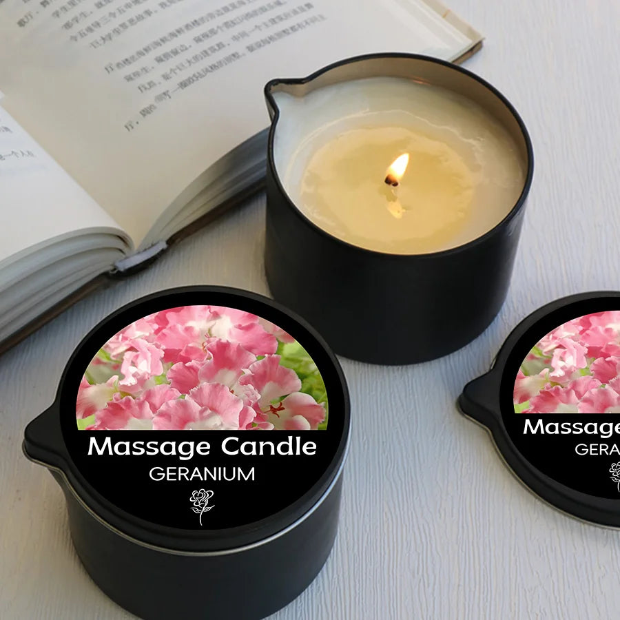 Massage candle with geranium scent on a white surface next to an open book