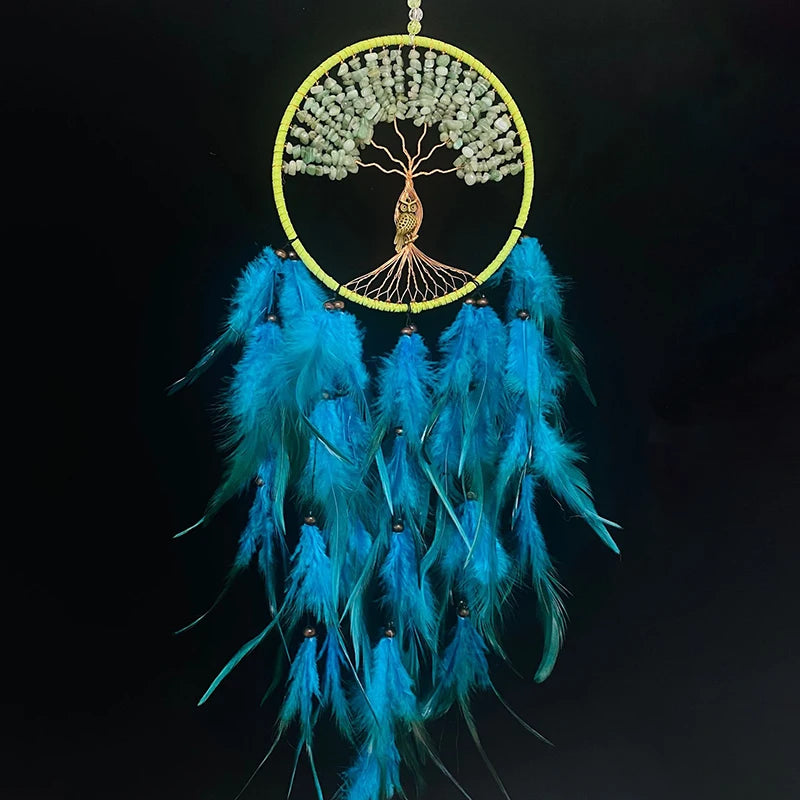 Dreamcatcher with blue feathers and tree-of-life design on a black background