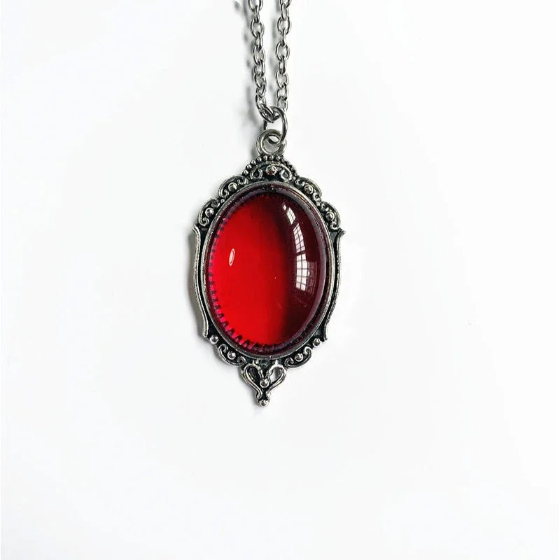 Necklace with a red oval pendant on a white background