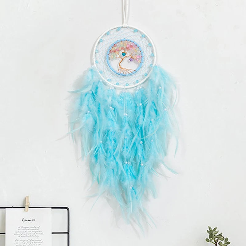 Decorative dreamcatcher with blue feathers on a white background
