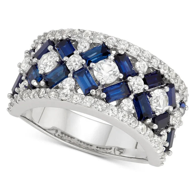 Ring with blue gemstones and diamonds on a white background