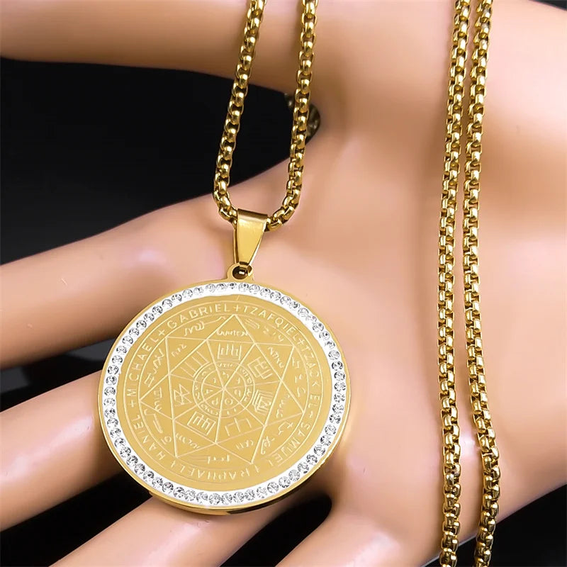 Gold pendant necklace with intricate design on a mannequin
