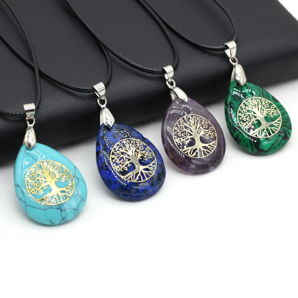 Four tree-of-life pendants in turquoise, blue, purple, and green on a white background.