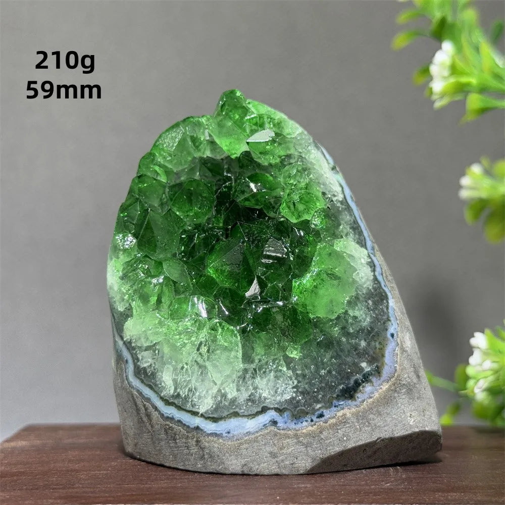 Green crystal geode on a wooden surface with a gray background