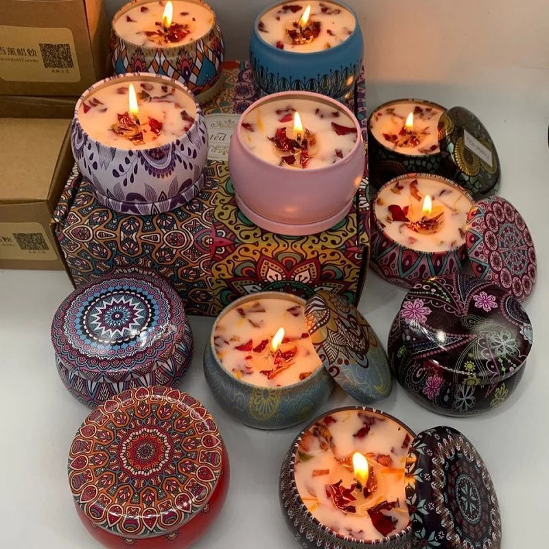 Decorative candles in colorful holders on a white surface
