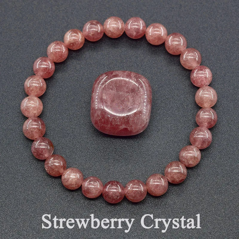 Strawberry crystal bracelet and stone on a gray background
