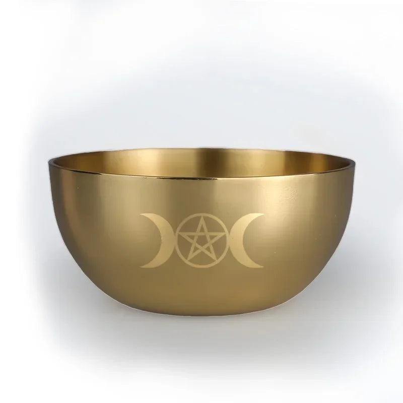 Gold bowl with engraved symbol on a white background
