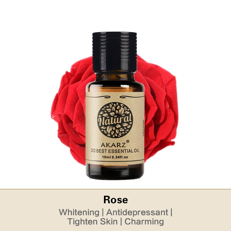 Essential oil bottle with a red rose on a white background