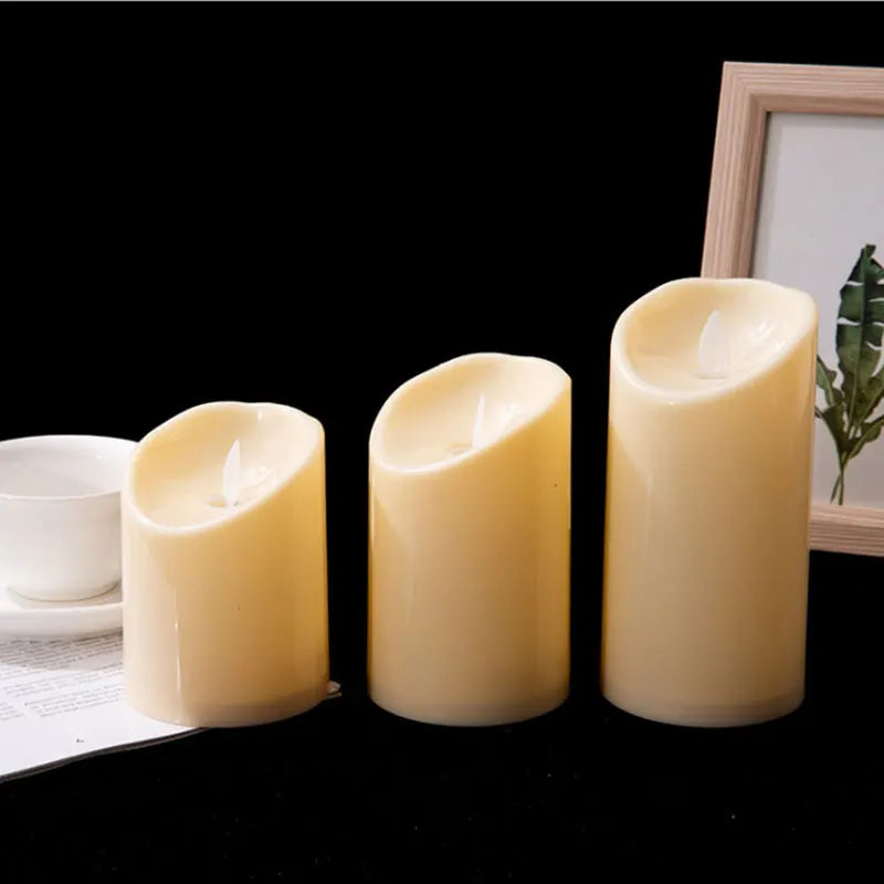 Three flameless candles on a table with a blurred background