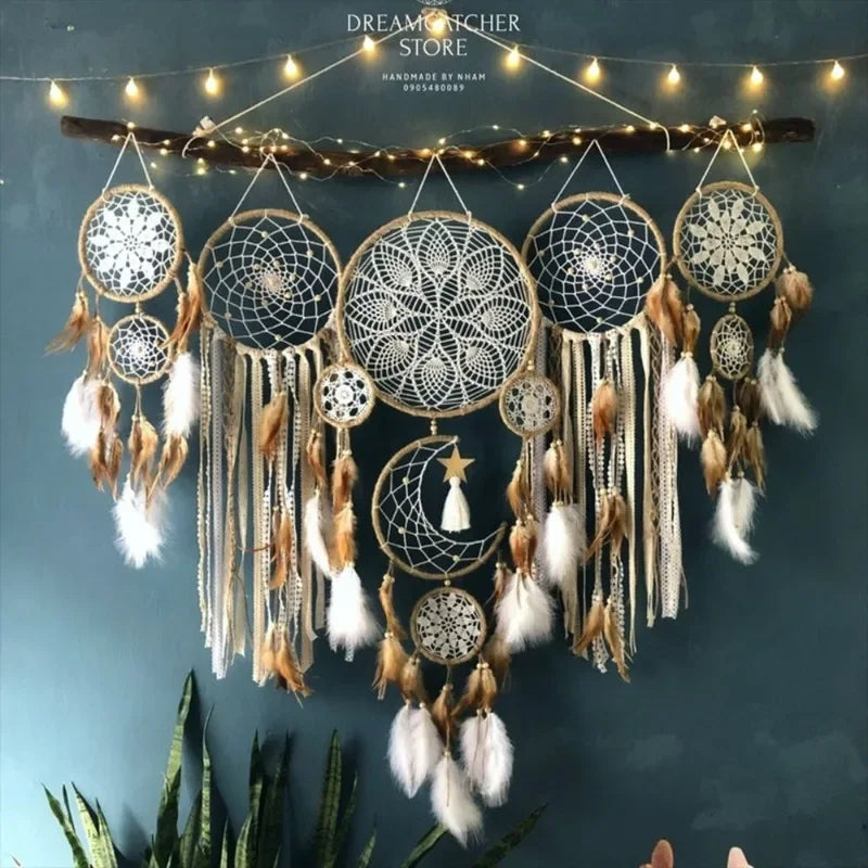 Decorative dreamcatcher with feathers and beads hanging against a dark blue wall with string lights.