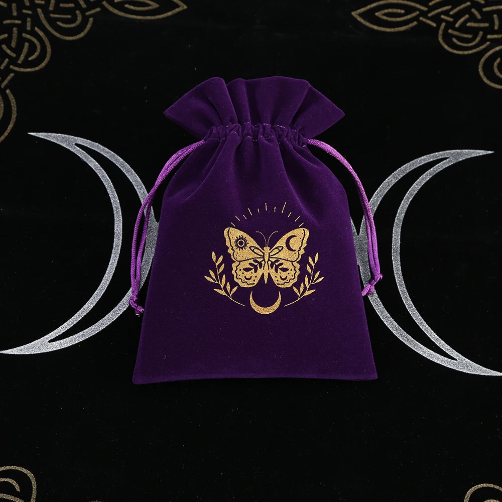 Purple drawstring bag with gold butterfly design on a black background with wiccan symbols.