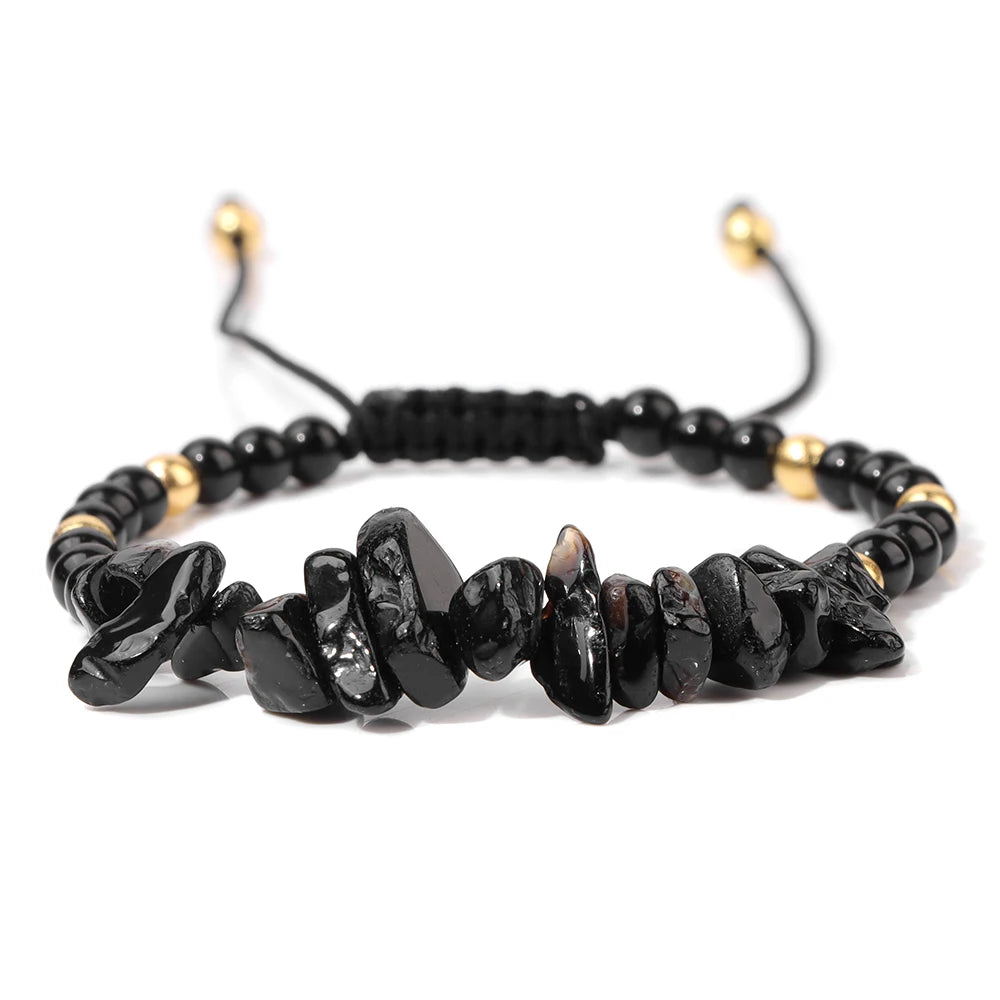 Black beaded bracelet with gold accents on a white background