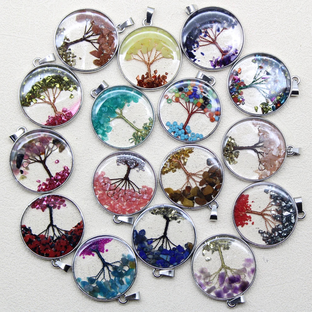 Collection of round pendants with tree designs in various colors on a light background