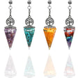 Set of four chakra stone pendulums with tree of life design on a white background