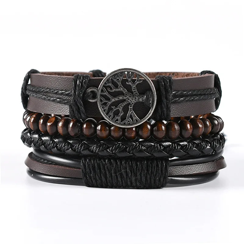 Stack of leather and wood bracelets with a central circular charm on a white background