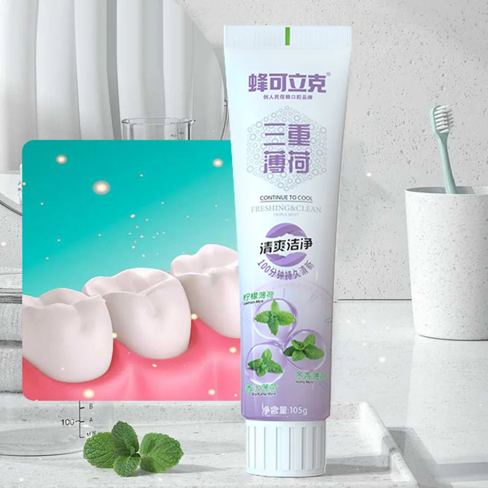 Tube of toothpaste with packaging and mint leaves on a bathroom background