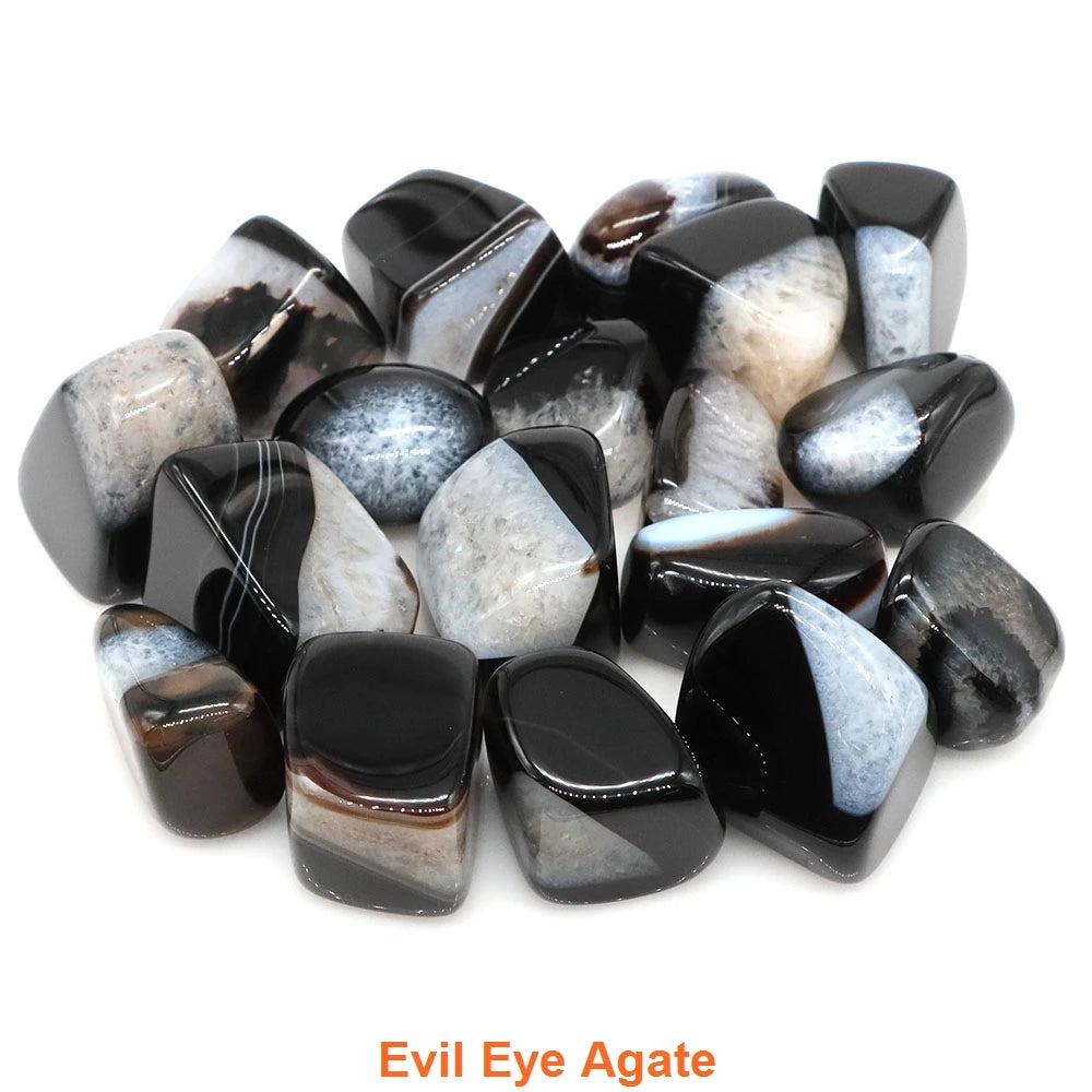 Collection of black and white agate stones labeled 'Evil Eye Agate' on a white background